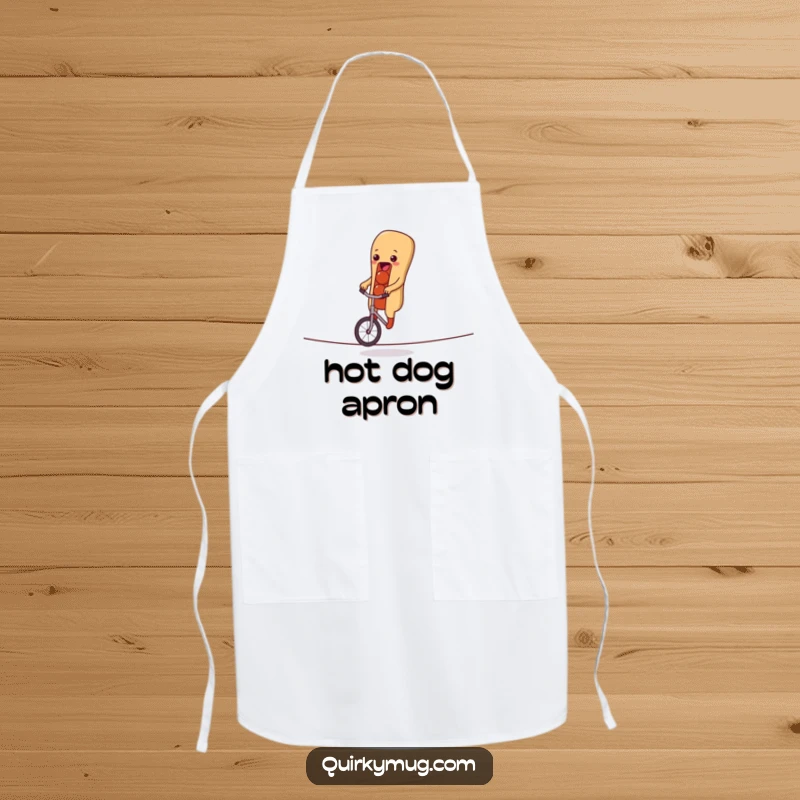 Funny apron with a hot dog character attempting a unicycle ride on a tightrope, perfect for adding humor to cooking adventures.
