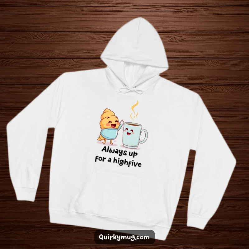 Funny croissant pastry attempting a high-five with a bewildered mug, cozy hoodie, perfect funny gift.