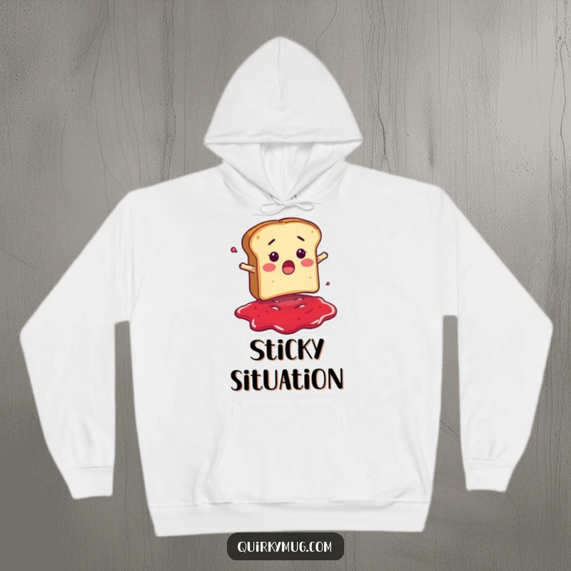 Funny hoodie featuring a surprised bread slice character falling headfirst into a puddle of jam, perfect for cozy, humorous mornings.