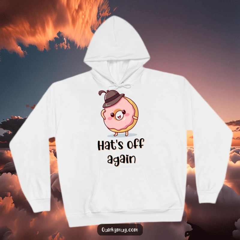 Funny donut character comically struggling with a small hat, bringing warmth and humor to this cozy hoodie design.