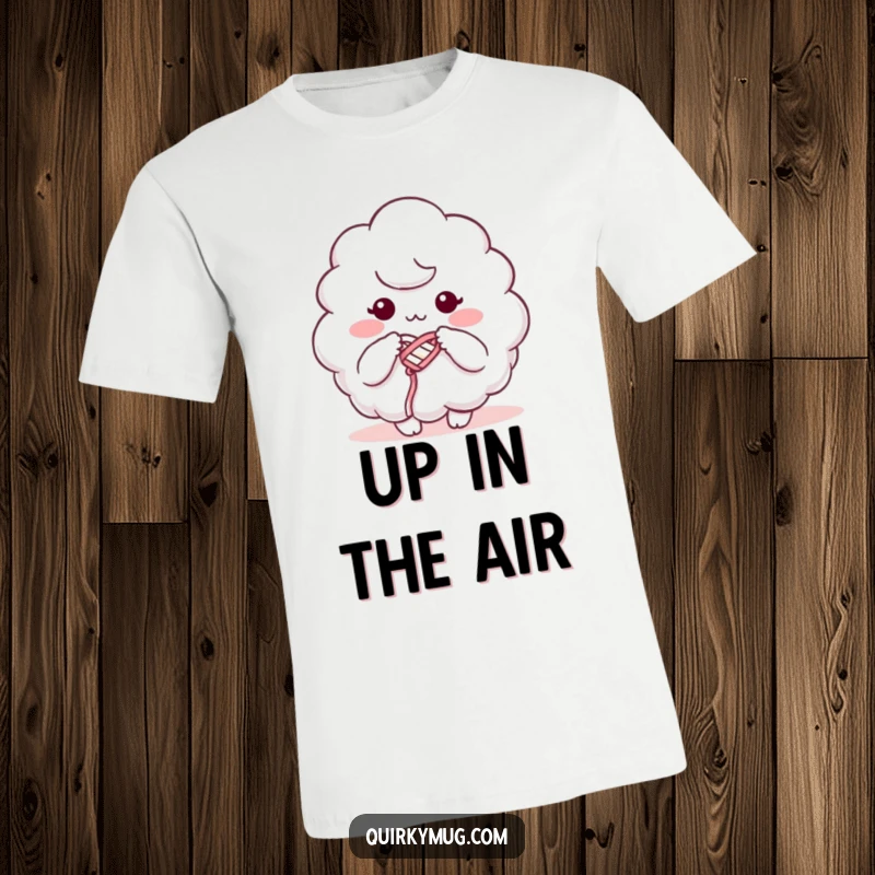 Funny t-shirt with a fluffy cloud character humorously knitting using its own mist, embodying creative struggle with a smile.